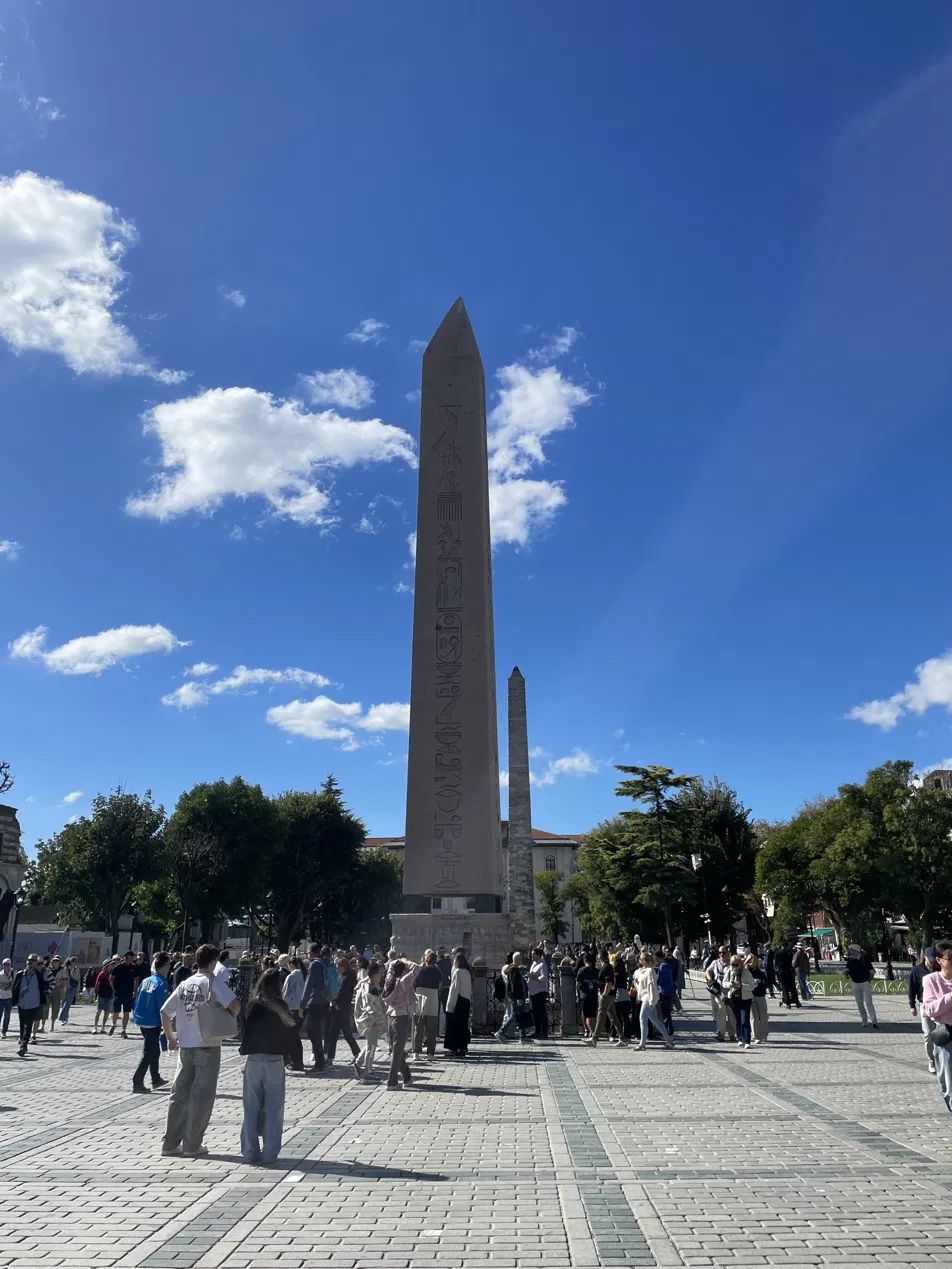 The Obelisk of Theodosius in Sultanahmet Square, with visitors around its base